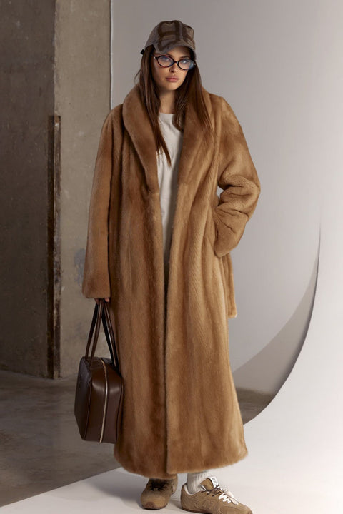 A woman steps out in a long, sumptuous mink coat with a soft sheen, combining sophistication with exceptional cold-weather comfort.
