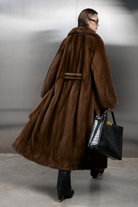 Luxurious long genuine brown mink fur coat with satin lining, showcasing elegance and warmth in fashion.