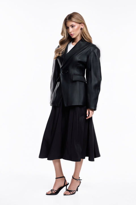 A woman wearing a sophisticated black leather blazer, crafted from supple leather and tailored to highlight the feminine shape, perfect for both professional wear and chic, casual moments.