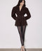 A woman models a refined brown suede blazer featuring a flattering fitted waist and timeless silhouette, styled with black tights for a chic work or casual outfit.