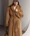 Elegant and refined, a woman is draped in a genuine mink fur coat that flows gracefully to the ankles, radiating classic luxury.