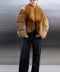 Stylish woman dressed in a voluminous red fox fur coat, showcasing the rich natural tones and softness of the genuine fur.